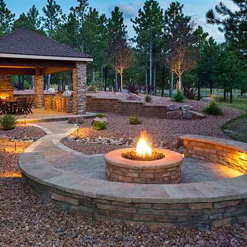 Stone fire pit patio at dusk
